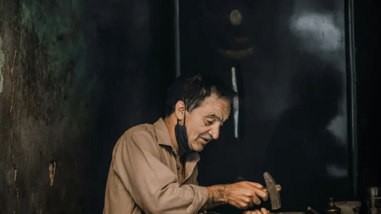 man hammering on his diy seed phrase storage
