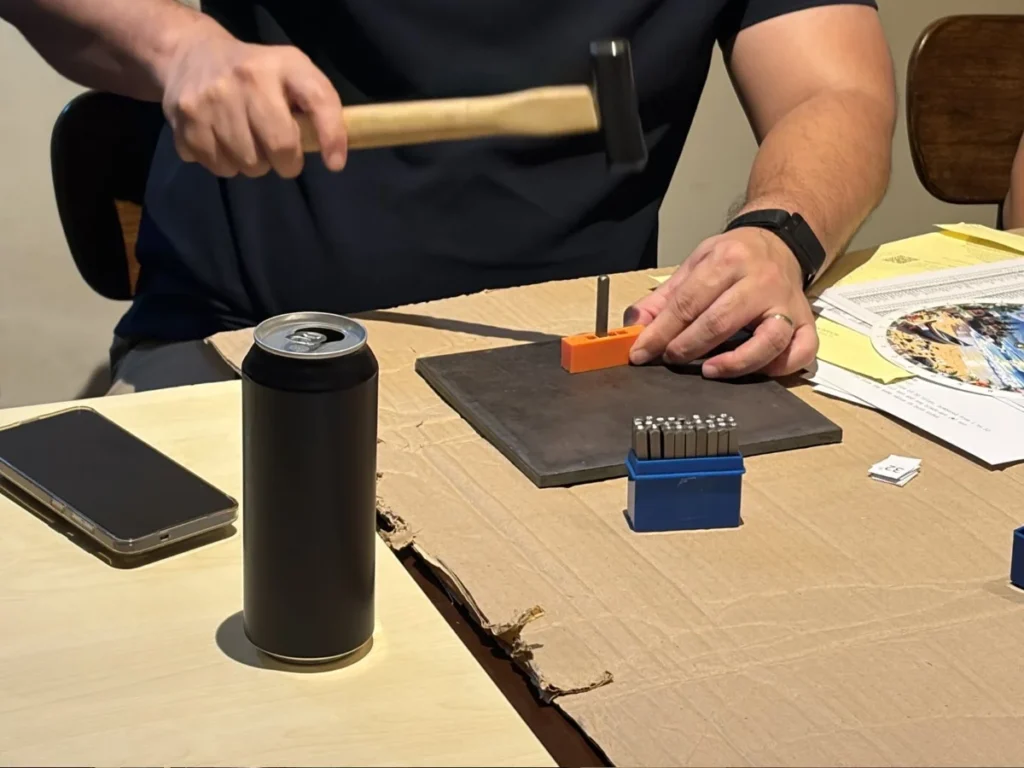 user stamping a metal seed keys during the workshop